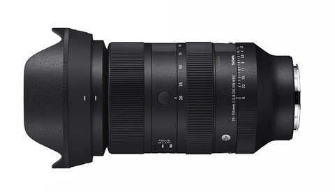Black telephoto zoom lens with hood attached, viewed from the side against a white background.