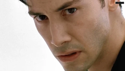 Close-up portrait of a man with a serious expression against a white background.