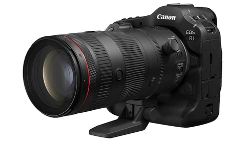 Canon EOS R1 mirrorless camera with attached telephoto lens on white background.