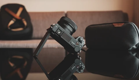Sony mirrorless camera mounted on a gimbal stabilizer in an indoor studio setting.