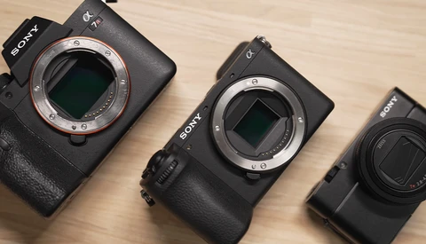 Three Sony mirrorless camera bodies arranged side by side, displaying their sensor mounts and varying sizes.