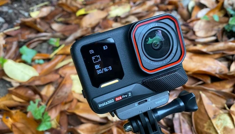 Insta360 Ace Pro 2 action camera mounted on tripod against forest floor background.