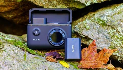 Liano instant camera and Oion battery pack displayed on moss-covered rock with autumn leaves.