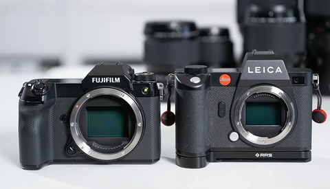Fujifilm and Leica mirrorless cameras displayed side-by-side, showing sensor openings and control layouts.