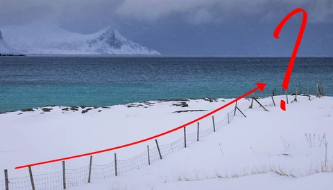 Snowy beach with fence line and red directional arrow overlay pointing upward across the landscape.