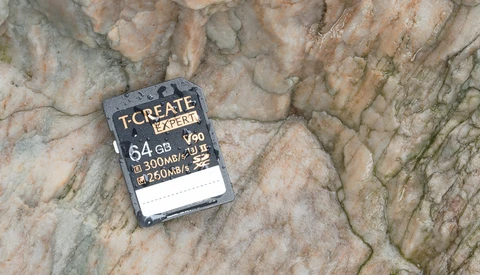 T-Create Expert 64GB SD card displaying 300MB/s write speed specifications on textured stone surface.