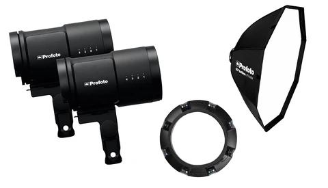 Profoto studio lighting kit with two monolight heads, octabox softbox, and adapter ring displayed against white background.