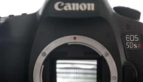 Canon EOS 5DS DSLR camera body with mirror open, showing the sensor and internal mirror mechanism.