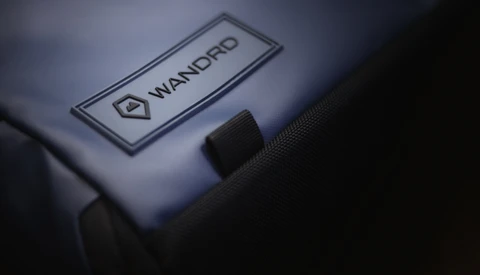 Close-up of a Wandpro branded label on camera equipment with dramatic side lighting.