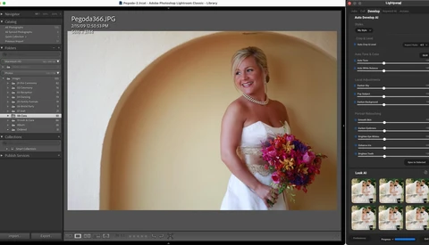 Bride in white strapless dress holding vibrant pink and yellow bouquet against curved golden arch backdrop.