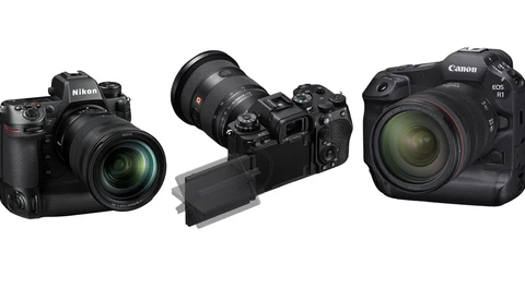 Three professional mirrorless cameras displayed side by side with attached lenses.