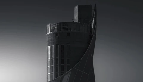 Modern cylindrical tower building with curved architectural elements photographed in monochrome.