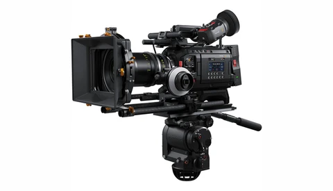 Professional cinema camera with matte box and follow focus mounted on fluid head tripod.
