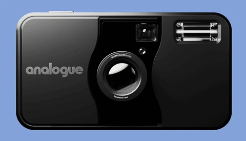 Analogue brand 35mm film camera with black body, fixed lens, and pop-up flash against blue background.
