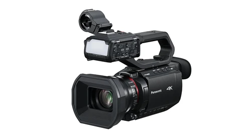 Panasonic 4K professional camcorder with flip-out monitor and shoulder-mounted viewfinder.
