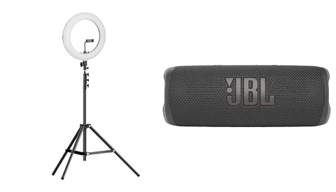 Ring light on tripod stand and portable JBL speaker displayed side by side.