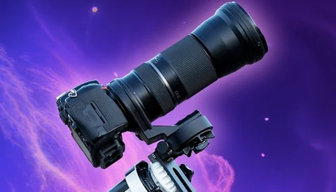 Camera with telephoto lens mounted on tripod against purple gradient background with light effects.