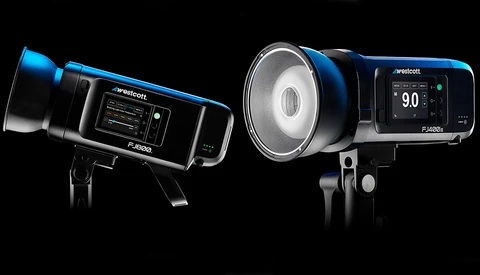 Two Westcott professional studio flash units with blue accents and digital control panels, photographed against black background.