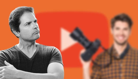 Man in dark v-neck shirt looking upward with thoughtful expression against orange background.