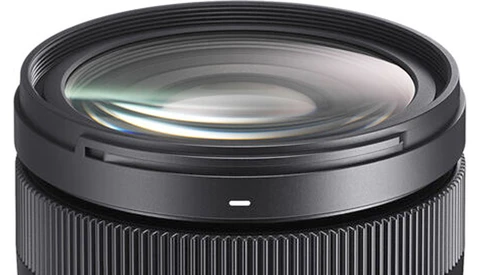 Close-up of a wide-angle camera lens showing glass elements and internal optics.