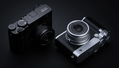 Two compact rangefinder cameras displayed on a dark background, showing top and front views.