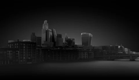 Monochromatic cityscape with modern skyscrapers reflected in still water below.