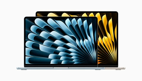 Two laptop displays showing dynamic radial stripe patterns in blue and gold tones.