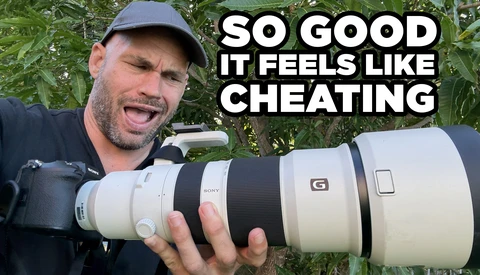 Photographer holding a white telephoto lens outdoors with text overlay saying "SO GOOD IT FEELS LIKE CHEATING."
