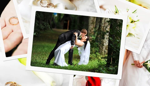 Groom dipping bride during kiss on grass, surrounded by wedding photos and rings.
