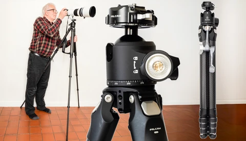 Photographer with telephoto lens on tripod next to ball head and carbon fiber tripod display.