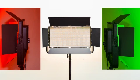 Three studio LED panel lights shown from the side with wings open, illuminated against red, neutral, and green backgrounds.