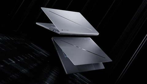 Two laptops displayed at angles against a dark background with diagonal light streaks.