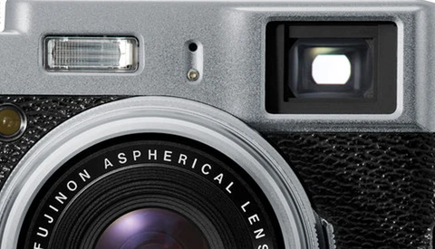 Close-up of a vintage rangefinder camera with Fujinon Aspherical lens and flash attachment.