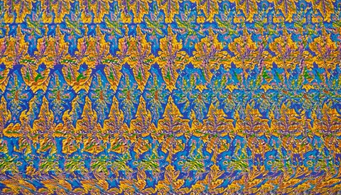 Abstract stereogram pattern with repeating golden leaf shapes layered across vibrant blue and green background.