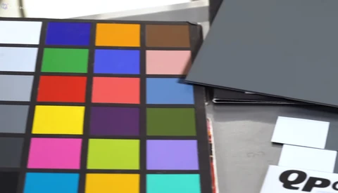 Color checker chart with calibration reference squares and white balance card visible at edge.