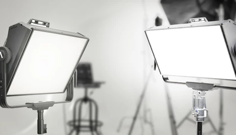 Two panel LED studio lights mounted on stands in a professional photography setup.