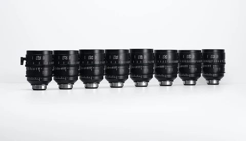 Eight cinema prime lenses arranged in a row, displaying focal lengths from 14mm to 85mm.