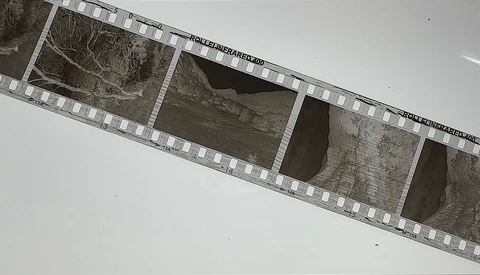 Film strip showing architectural details and concrete structures in black and white.
