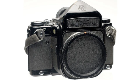 Black medium format film camera body shown from front-left angle against white background.