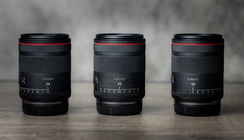 Three Canon RF mount lenses displayed side by side showing 24mm, 35mm, and 50mm focal lengths.