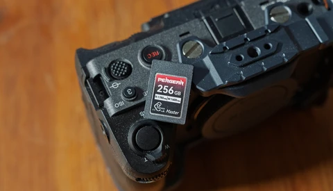 Close-up of camera grip showing memory card slot with 256GB Rekordth card inserted.