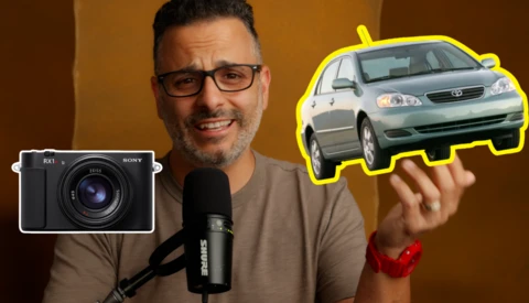 Man with microphone holds illustrations of a Sony camera and a taxi car against an orange backdrop.