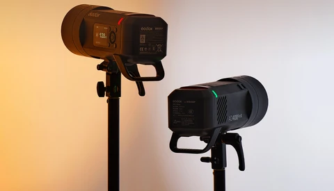 Two professional LED studio lights mounted on stands with warm and cool color temperatures.