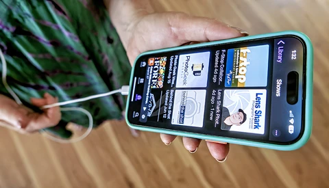 Smartphone displaying a photography education website with course listings and instructor profiles.