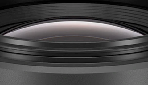 Cross-section view of a camera lens showing internal glass elements and optical construction.