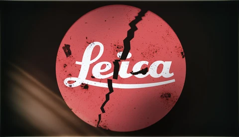 Graphic design featuring the Leica logo with a jagged crack running through a red circular background.