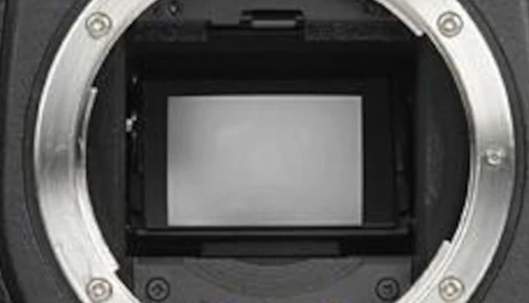 Camera sensor and mirror box interior viewed from the front, showing the reflective mirror and focusing screen assembly.