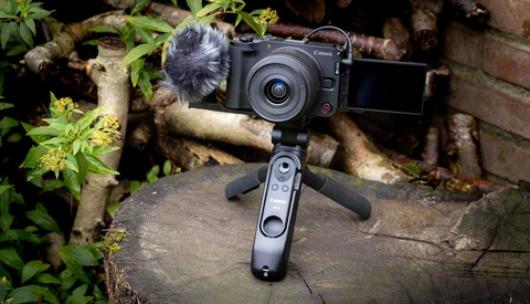 Canon mirrorless camera with articulating screen mounted on a gimbal stabilizer with wireless remote control.