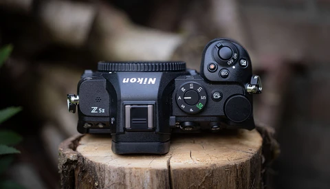 Top-down view of a Nikon Z5 mirrorless camera on a wooden surface.