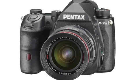 Pentax K3 III DSLR camera with attached lens on white background.